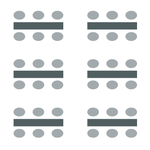 Tables arrange in columns with seating on both sides of the table. 