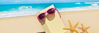 Book and sunglasses on beach