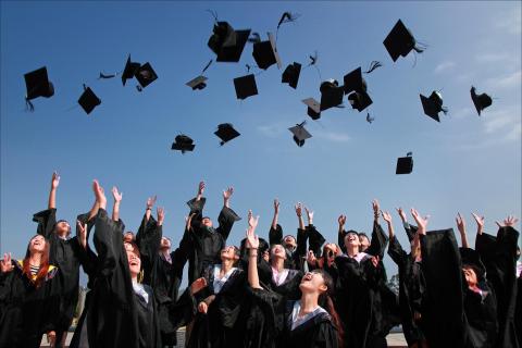 Graduates throwing mortarboards