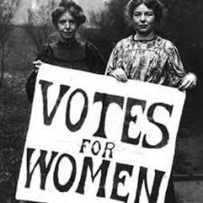 black and white photo of two women with "Votes for Women" sign 