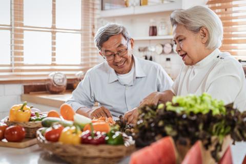 Two people in the kitchen preparing food