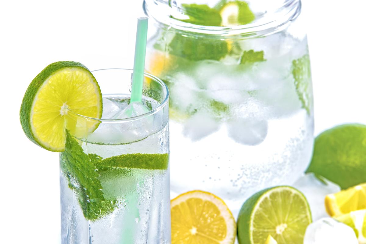 pitcher and glass with water and limes