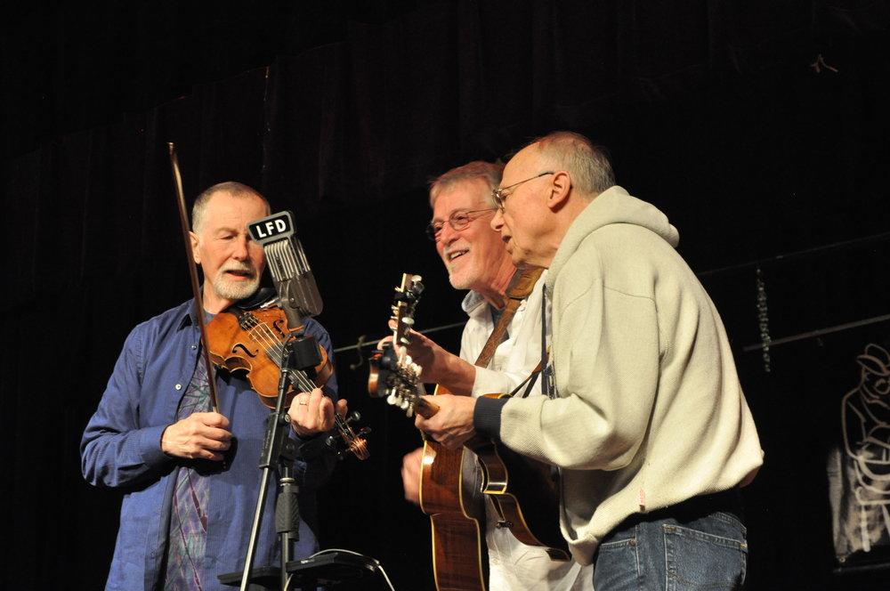 three men playing instruments