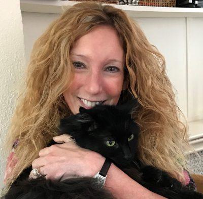 Presenter holding black cat