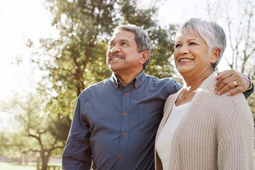 A man and woman standing close together outside