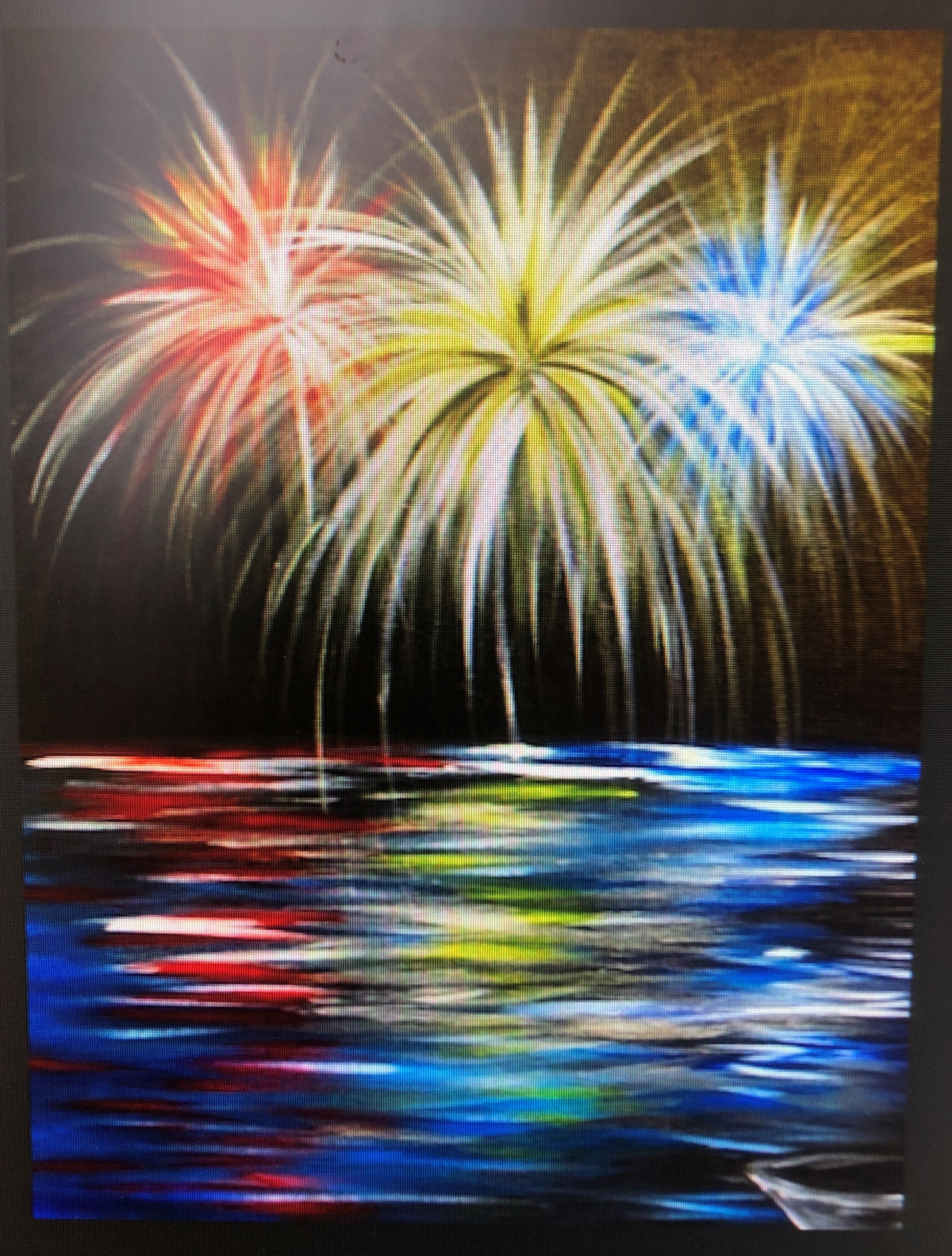 red, white, and blue fireworks over a lake with a small white boat on a black canvas